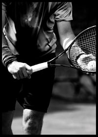 Black and white photo of tennis player with racket and ball-6
