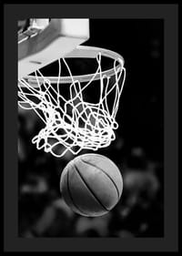 Black and white close-up of basketball going through basket-0