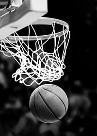 Black and white close-up of basketball going through basket-7