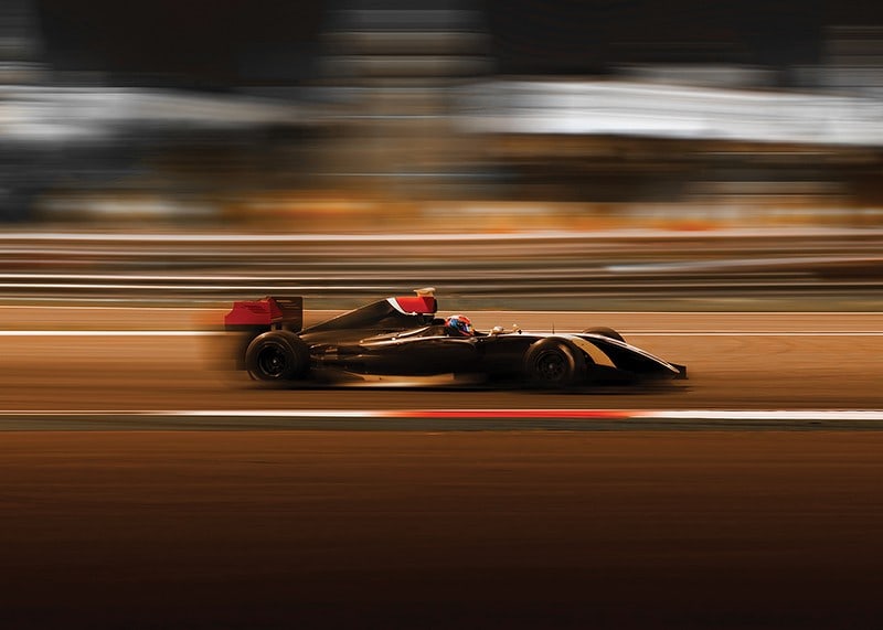 Formula 1 car at high speed with blurred background in warm colors-12