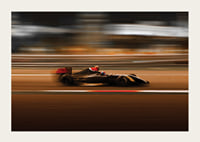 Formula 1 car at high speed with blurred background in warm colors-3