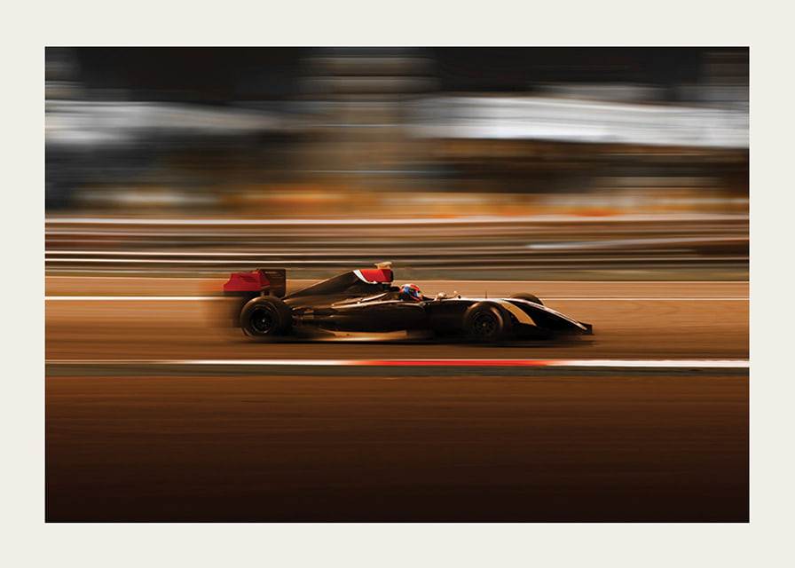 Formula 1 car at high speed with blurred background in warm colors-12