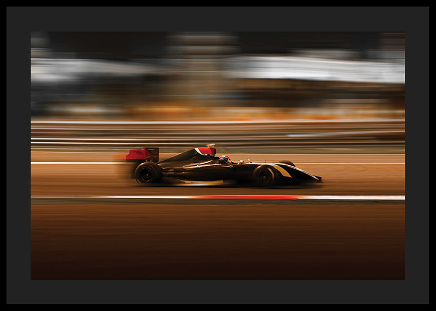 Formula 1 car at high speed with blurred background in warm colors-12