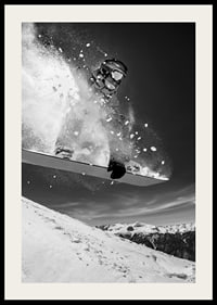 Black and white action shot of snowboarder in the middle of a jump-2