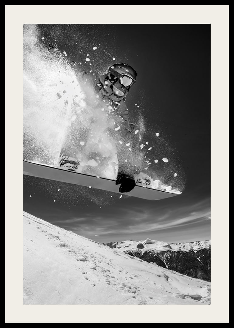 Black and white action shot of snowboarder in the middle of a jump-12