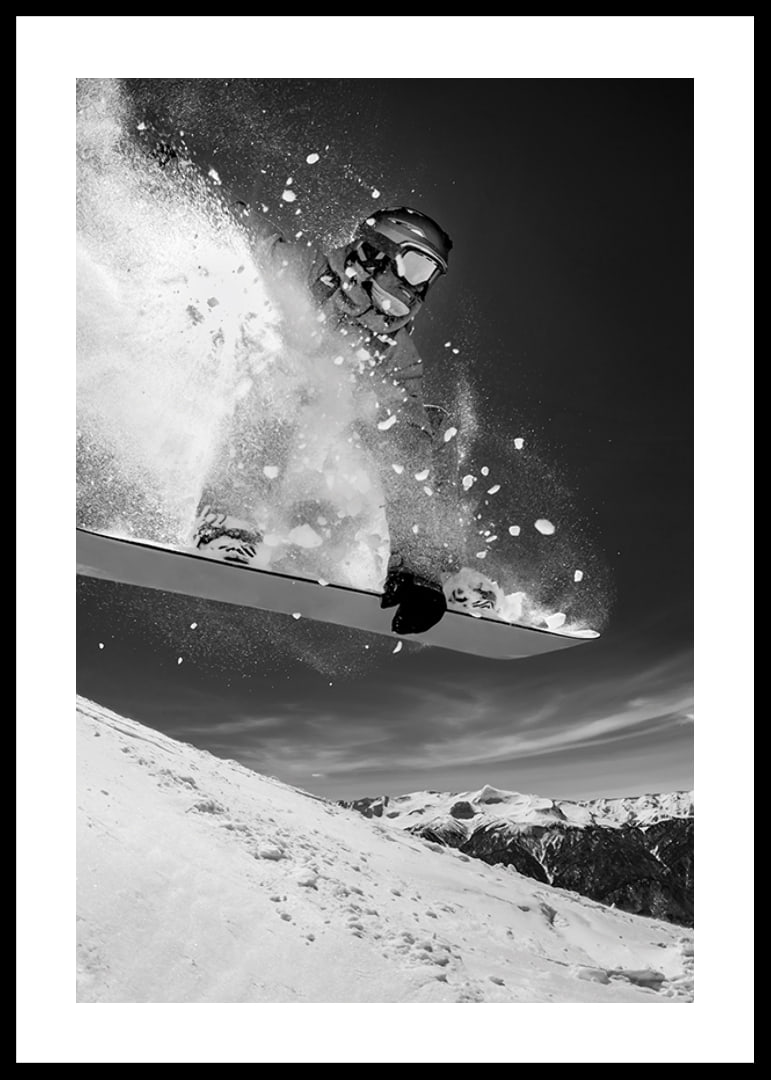 Black and white action shot of snowboarder in the middle of a jump-12