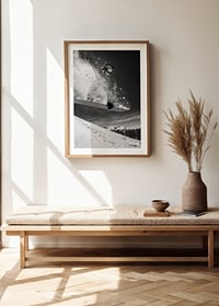 Black and white action shot of snowboarder in the middle of a jump-8