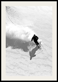 Black and white skier moving down snow-covered mountainside-2