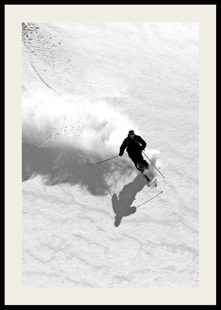 Black and white skier moving down snow-covered mountainside-12