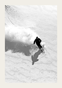 Black and white skier moving down snow-covered mountainside-3