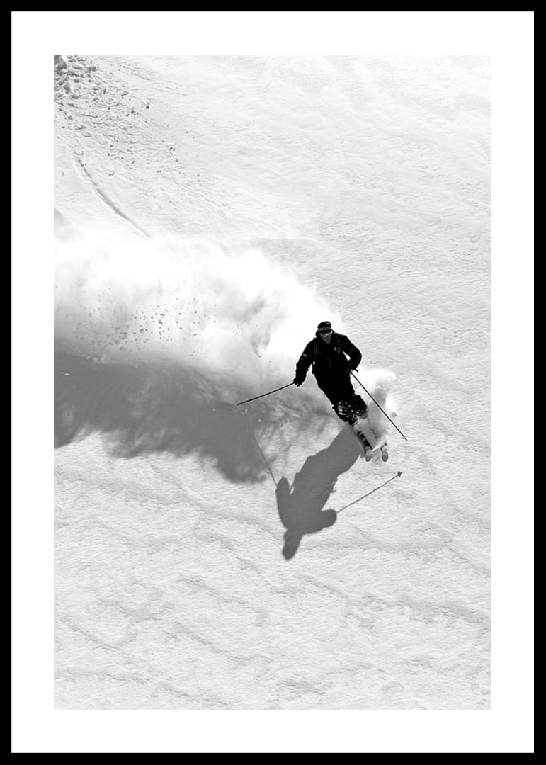 Black and white skier moving down snow-covered mountainside-12