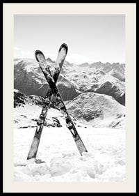 Black and white photo of crossed skis in snowy alpine landscape-2