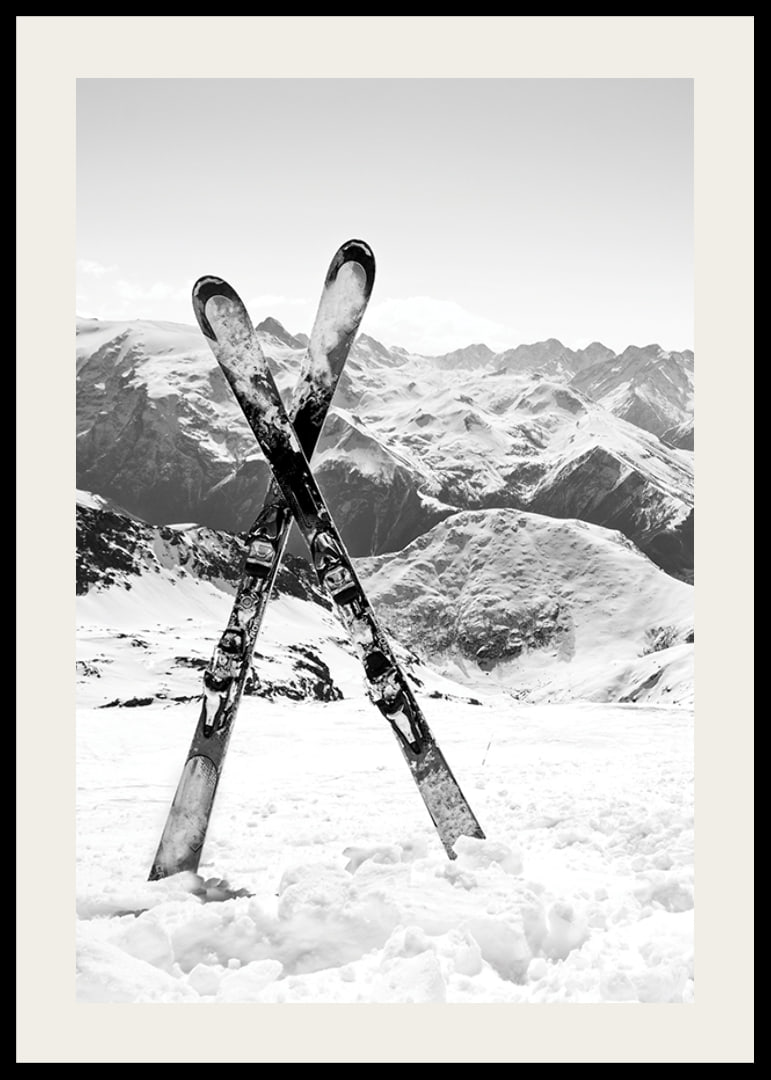 Black and white photo of crossed skis in snowy alpine landscape-12
