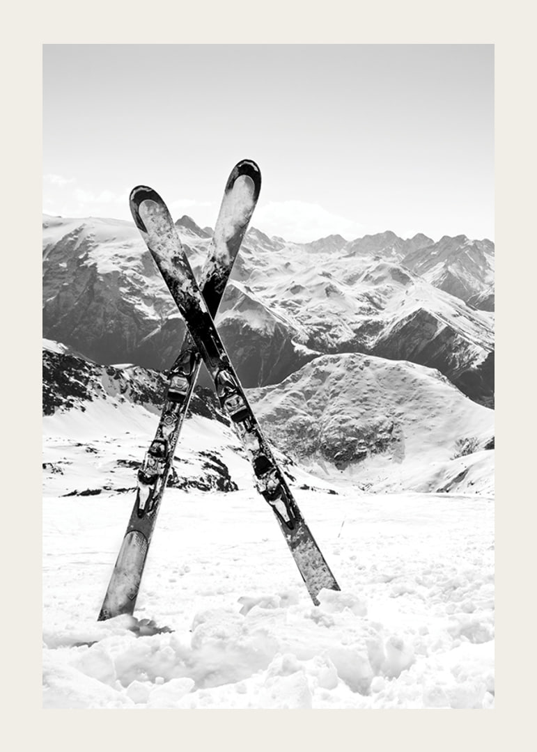 Black and white photo of crossed skis in snowy alpine landscape-12