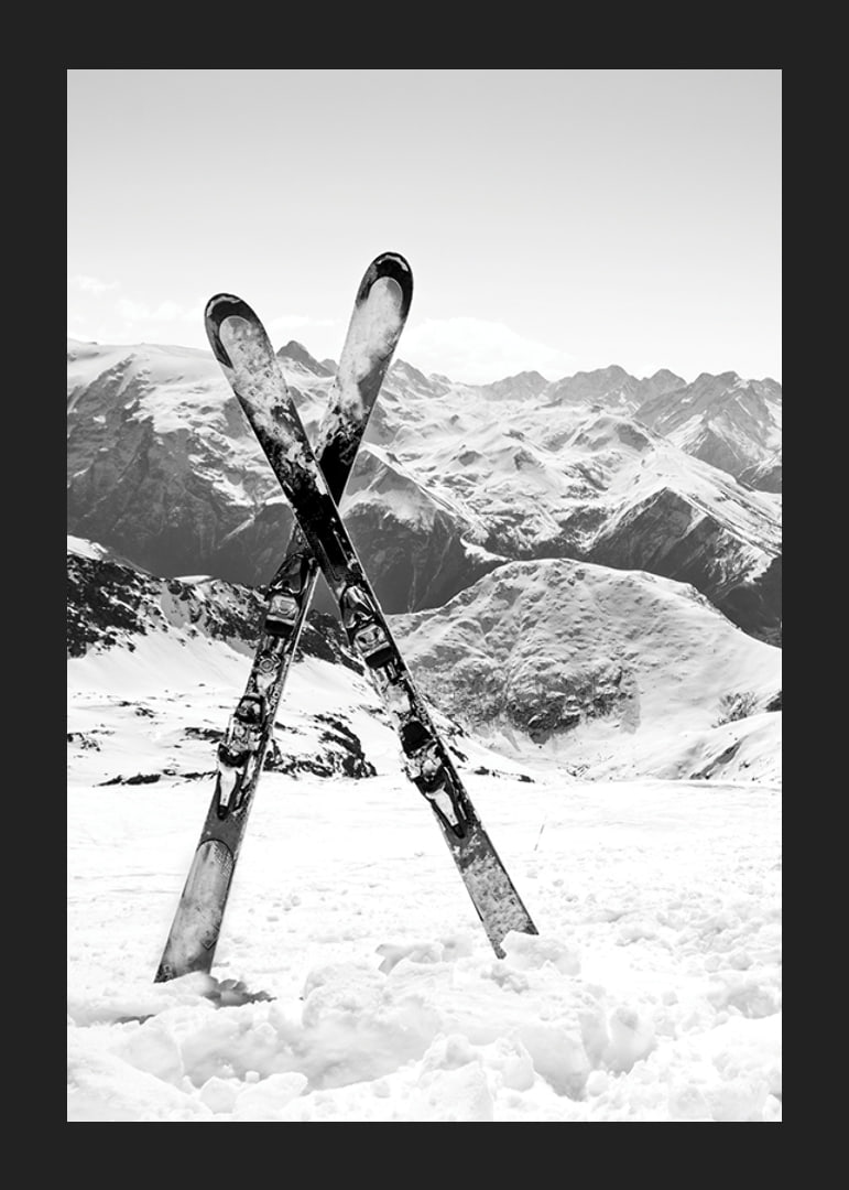 Black and white photo of crossed skis in snowy alpine landscape-12