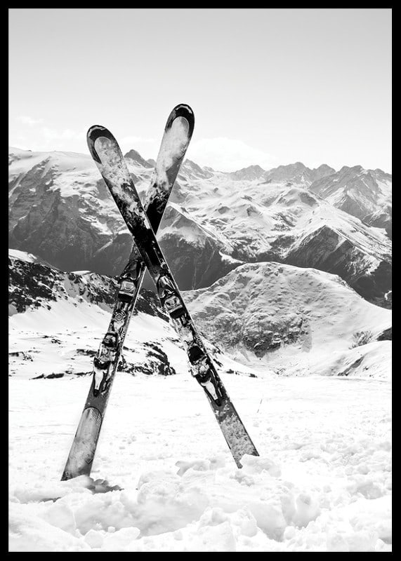 Black and white photo of crossed skis in snowy alpine landscape-12