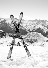 Black and white photo of crossed skis in snowy alpine landscape-7