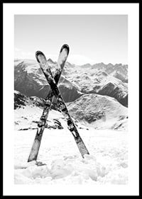 Black and white photo of crossed skis in snowy alpine landscape-0