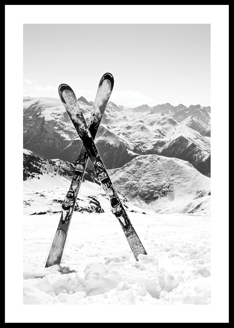 Black and white photo of crossed skis in snowy alpine landscape-12