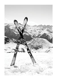 Black and white photo of crossed skis in snowy alpine landscape-1
