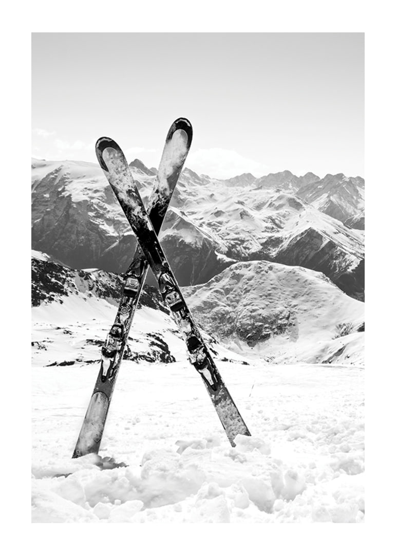 Black and white photo of crossed skis in snowy alpine landscape-12