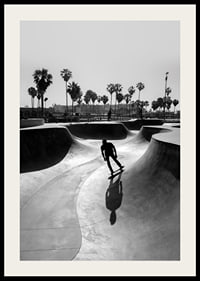 Black and white photograph of skateboarder in concrete park with palm trees-2