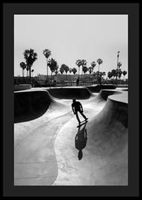 Black and white photograph of skateboarder in concrete park with palm trees-4