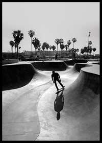Black and white photograph of skateboarder in concrete park with palm trees-6