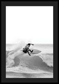 Black and white surfer caught in the middle of a wave jump-4