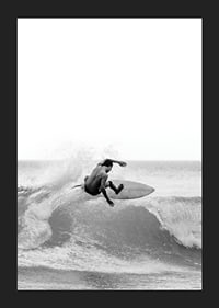 Black and white surfer caught in the middle of a wave jump-5