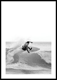 Black and white surfer caught in the middle of a wave jump-0