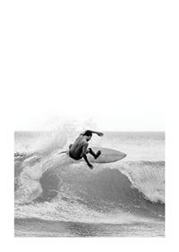 Black and white surfer caught in the middle of a wave jump-1