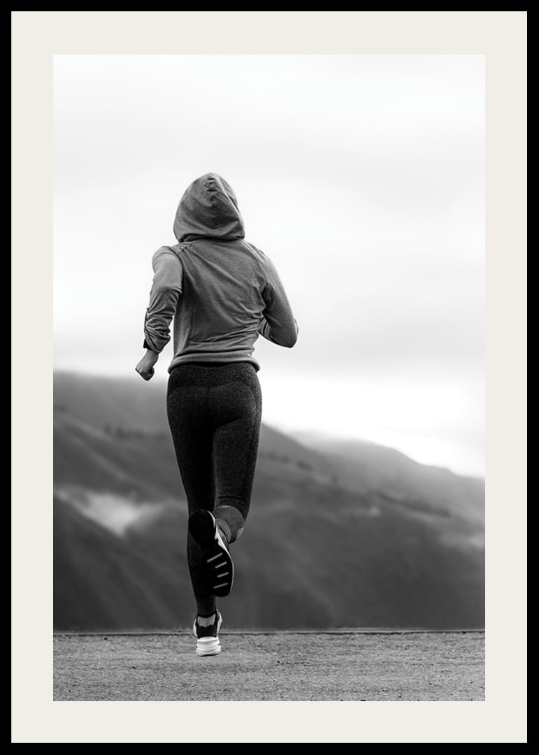 Black and white photographed woman running outdoors with mountains in the background-12