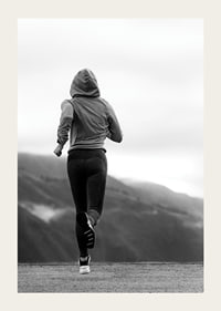 Black and white photographed woman running outdoors with mountains in the background-3