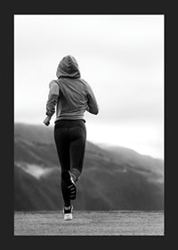 Black and white photographed woman running outdoors with mountains in the background-5