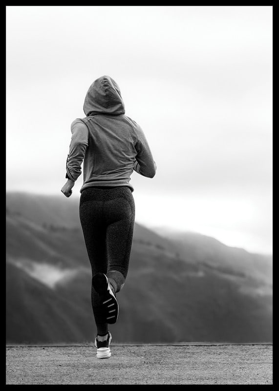 Black and white photographed woman running outdoors with mountains in the background-12