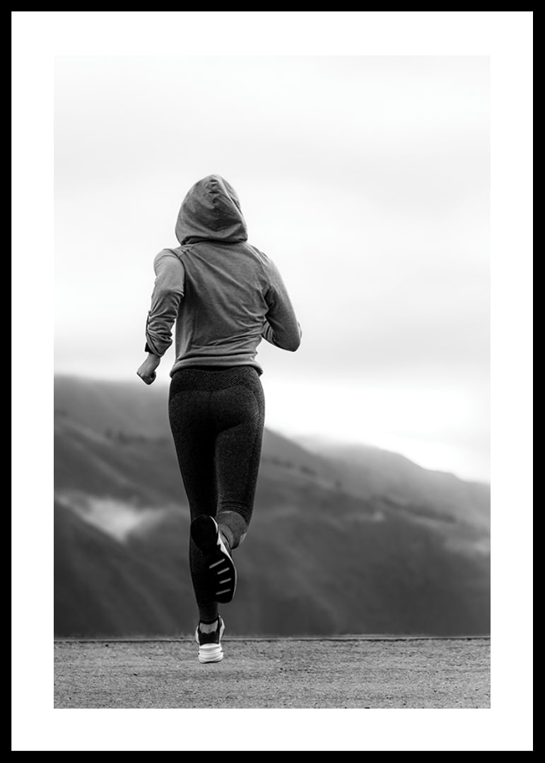 Black and white photographed woman running outdoors with mountains in the background-12