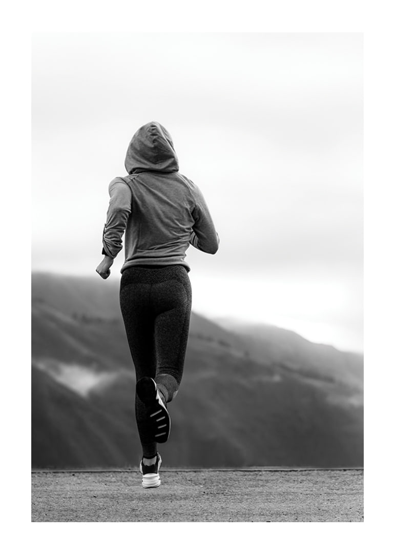 Black and white photographed woman running outdoors with mountains in the background-12
