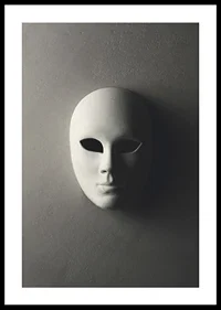 White theater mask with smooth features against gray wall in shadowy light-0