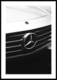 Black and white close-up of Mercedes grille with emblem in focus-0