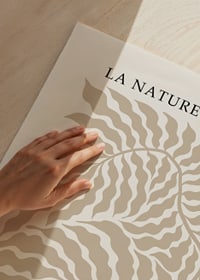 Abstract sand-colored leaf shapes against light background-3