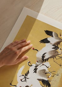 Classical painting of cranes in a group against a golden yellow background-3