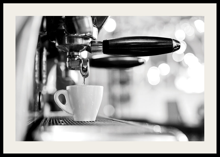 Black and white photo of espresso machine with cup during brewing-12