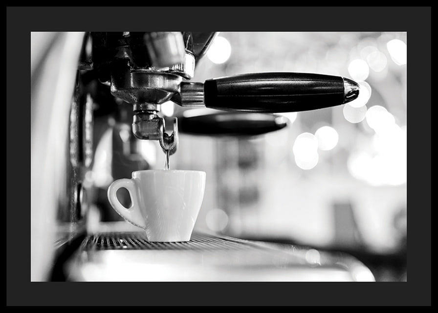 Black and white photo of espresso machine with cup during brewing-12