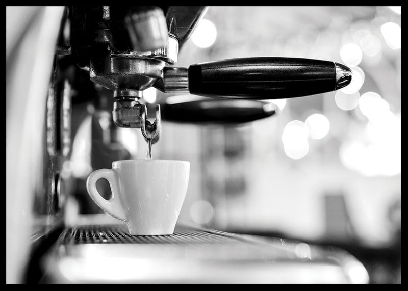 Black and white photo of espresso machine with cup during brewing-12