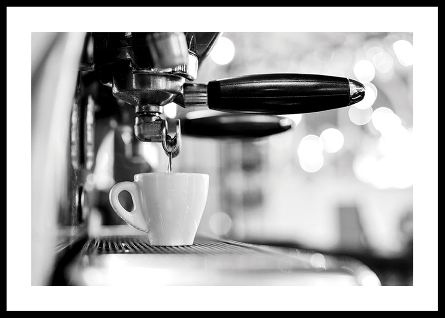 Black and white photo of espresso machine with cup during brewing-12