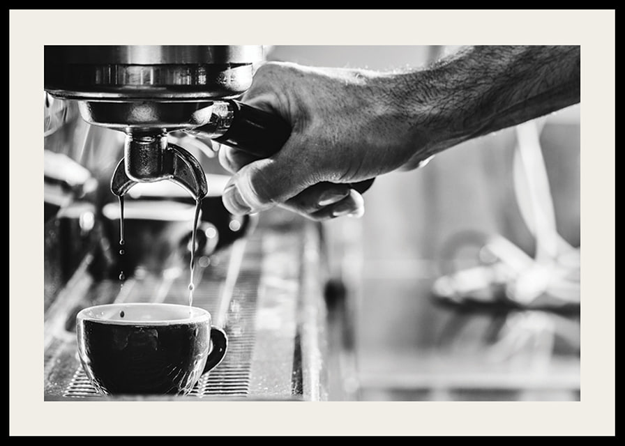 Black and white photo of hand brewing espresso in cup-12