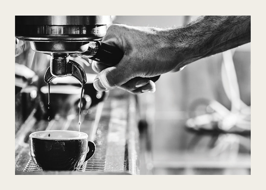 Black and white photo of hand brewing espresso in cup-12