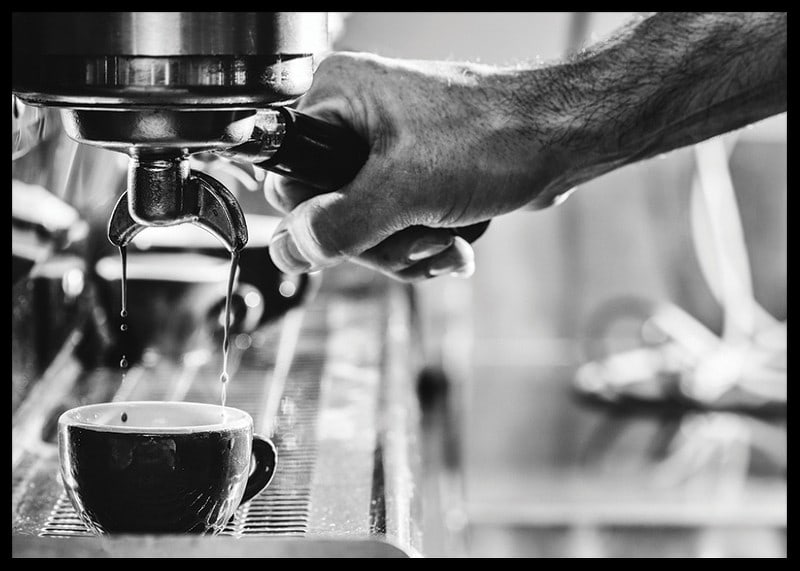 Black and white photo of hand brewing espresso in cup-12