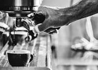 Black and white photo of hand brewing espresso in cup-7